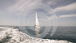 Amazing seascape with white sailing boat in blue sea.