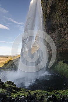 Amazing Seljalandfoss waterfall in sunny autumn day, Iceland. Famous tourist attraction