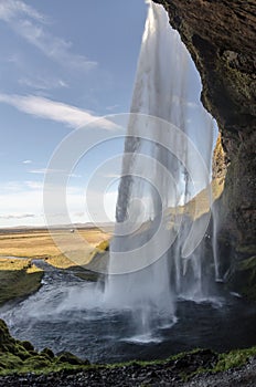 Amazing Seljalandfoss waterfall in sunny autumn day, Iceland. Famous tourist attraction