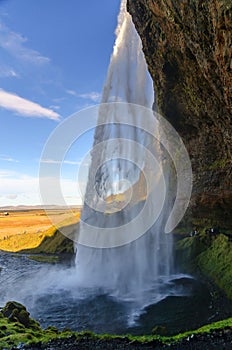 Amazing Seljalandfoss waterfall in sunny autumn day, Iceland. Famous tourist attraction