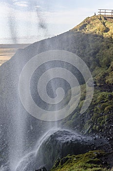 Amazing Seljalandfoss waterfall in sunny autumn day, Iceland. Famous tourist attraction