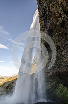 Amazing Seljalandfoss waterfall in sunny autumn day, Iceland. Famous tourist attraction