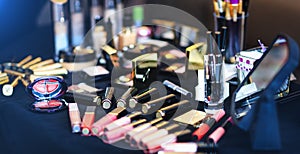 Amazing set of cosmetic products lie on table. Real make up brushes of professional beautician.