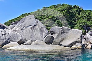 Amazing Similan island. On the shores of the turquoise sea lie huge ancient smooth boulders.