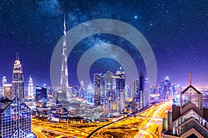Amazing skyline cityscape with illuminated skyscrapers. Downtown of Dubai at night with stars and milky way, United Arab Emirates