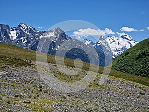 Amazing snowy and green mountains in summer against a cloudy sky. Minimalistic photo. Arkhyz, Karachay-Cherkessia, Russia