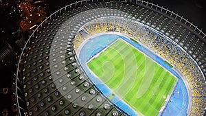 Amazing soccer stadium, glowing night lights, aerial view, sport event building