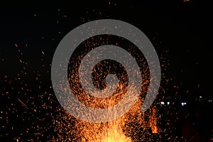 Amazing Sparks in the Dark. Beautiful abstract background on the theme of fire, light and life. Sparks fly in the sky