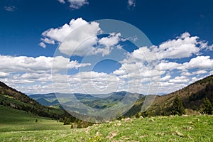 Amazing spring mountain landscape with blue sky and clouds