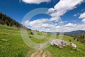 Amazing spring mountain landscape with blue sky and clouds