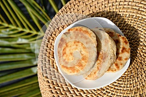 Amazing Sri Lankan three pol coconut roti in white plate. Authentic recipe.