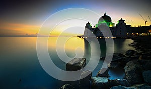 Amazing Straits Mosque of Malacca during sunrise with reflection