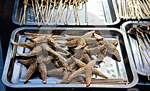 Amazing street food Roasted fried starfish as snack in china