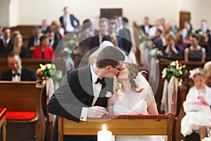 Amazing stylish cute groom and bride is kissing on the backgrou