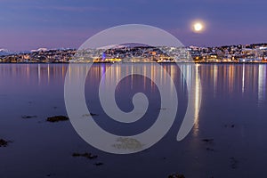 Amazing sunrise with amazing magenta color and moon over Tromso, Norway. Polar night. long shutter speed