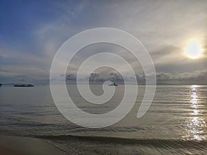 Amazing sunrise with boat in the sea. Beautiful beach of Hua Hin, Thailand