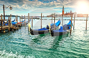 Amazing sunrise with gondolas harbor in Venice, Italy, Europe