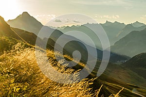 Beautiful sunrise and layered mountain silhouettes in early morning. Lechtal and Allgau Alps, Bavaria and Austria. photo