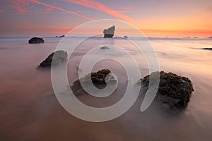 Amazing sunrise over Aguilar beach Asturias photo