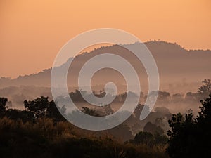 Amazing Sunrise Over Misty Landscape. Scenic View Of Foggy Morning Sky With Rising Sun Above Misty