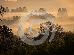 Amazing Sunrise Over Misty Landscape. Scenic View Of Foggy Morning Sky With Rising Sun Above Misty