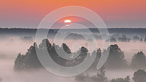 Amazing Sunrise Over Misty Landscape. Scenic View Of Foggy Morning Sky With Rising Sun Above Misty Forest And River