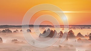 Amazing Sunrise Over Misty Landscape. Scenic View Of Foggy Morning Sky With Rising Sun Above Misty Forest And River