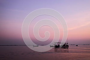 Amazing sunrise with silhouette image fishing boat view as a foreground.Nature composition:Ideal use for background