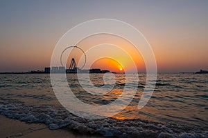 Amazing sunset colors over the sea view to the Ain Dubai, giant Ferris at Bluewaters Island  close to JBR beach.