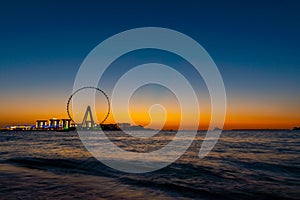 Amazing sunset colors over the sea view to the Ain Dubai, giant Ferris at Bluewaters Island  close to JBR beach.