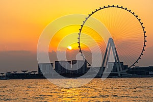Amazing sunset colors over the sea view to the Ain Dubai, giant Ferris at Bluewaters Island close to JBR beach.