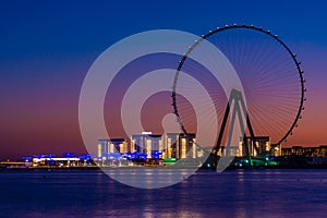 Amazing sunset colors over the sea view to the Ain Dubai, giant Ferris at Bluewaters Island close to JBR beach.