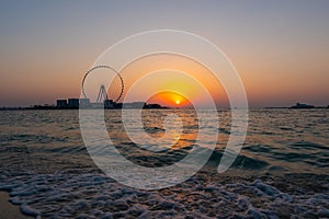 Amazing sunset colors over the sea view to the Ain Dubai, giant Ferris at Bluewaters Island  close to JBR beach.