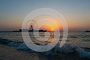 Amazing sunset colors over the sea view to the Ain Dubai, giant Ferris at Bluewaters Island  close to JBR beach.