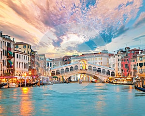 Amazing sunset and evening cityscape of Venice with famous Canal Grande and Rialto Bridge