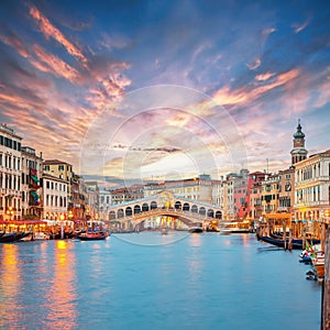 Amazing sunset and evening cityscape of Venice with famous Canal Grande and Rialto Bridge