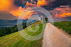 Amazing sunset landscape with Saint Primoz church, near Jamnik, Slovenia