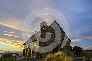 Amazing sunset at the most beautiful Church Of The Good Shepherd by Lake Tekapo, South Island, New Zealand. Dramatic sky, evening