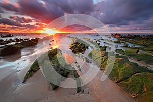 Amazing sunset over barrika beach Biscay, Basque Country scenary of Game of Thrones