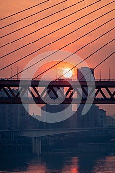 Amazing Sunset over bridge with moored boats in pier