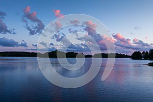 Amazing sunset over the lake. Beautiful colorful clouds in the morning. Summer nature landscape