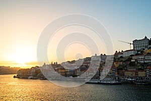 Amazing sunset over the Porto old town skyline on the Douro River, Portugal.