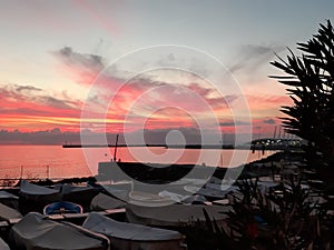 An amazing sunset over the sea of Genova in spring days with some people