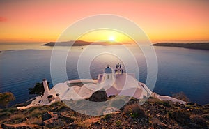 Amazing sunset at Panagia Theoskepasti, on the Skaros rock at Imerovigli, Santorini, Crete,