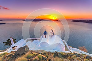 Amazing sunset at Panagia Theoskepasti, on the Skaros rock at Imerovigli, Santorini, Crete, Greece