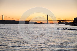 Amazing sunset on Ponte 25 de Abril Bridge, (25th of April Bridge) at Lisbon