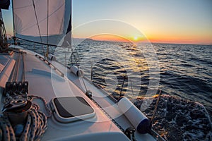 Amazing sunset on a sailing yacht ship boat at the Sea. Luxury.