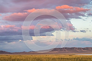 Amazing sunset sky with clouds under the steppe, Kazakhstan, Kegen