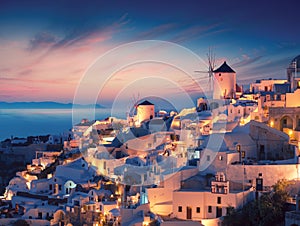 Amazing sunset view with white houses in Oia village on Santorini island in Greece
