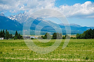 Amazing Tatra Mountains in Slovakia with blue sky background and grass field.